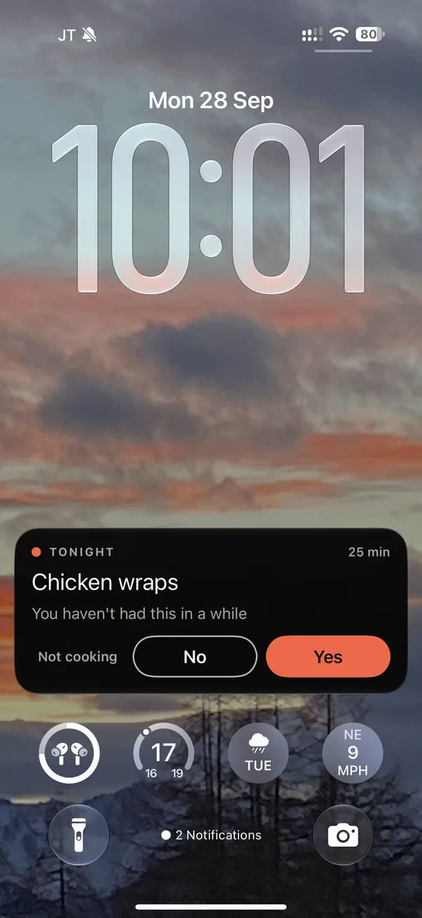 Tonight's card on the lock screen as a Live Activity: chicken wraps, you haven't had this in a while, with Not cooking, No and Yes buttons that answer without opening the app